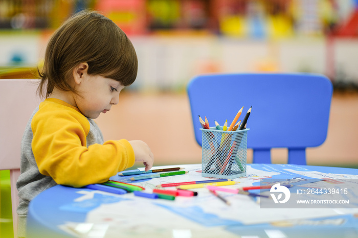 Creative baby development. Baby learns to draw. Early development of children in the Children’s Development Center. Happy kid draws.