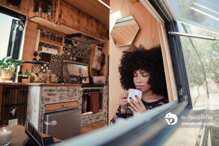 Woman relaxing in her camper van