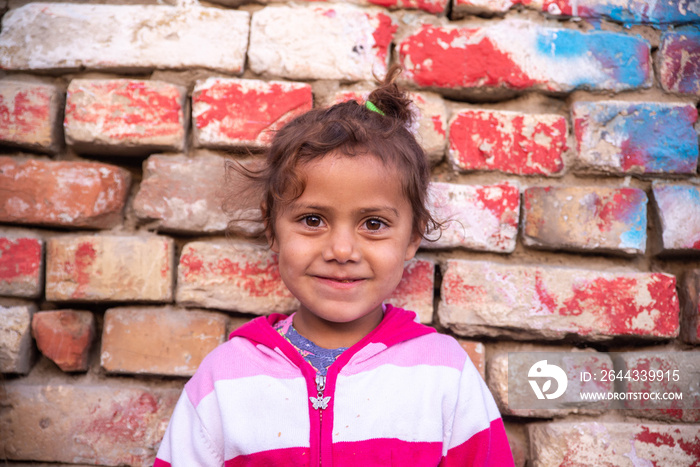 A portrait of a beautiful little gypsy girl on the street