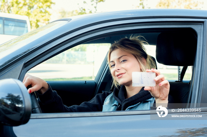 Girl portrait sititng in her car and driving license