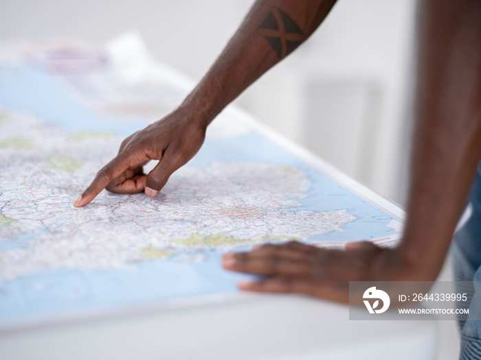 Close-up of hands pointing at map on table