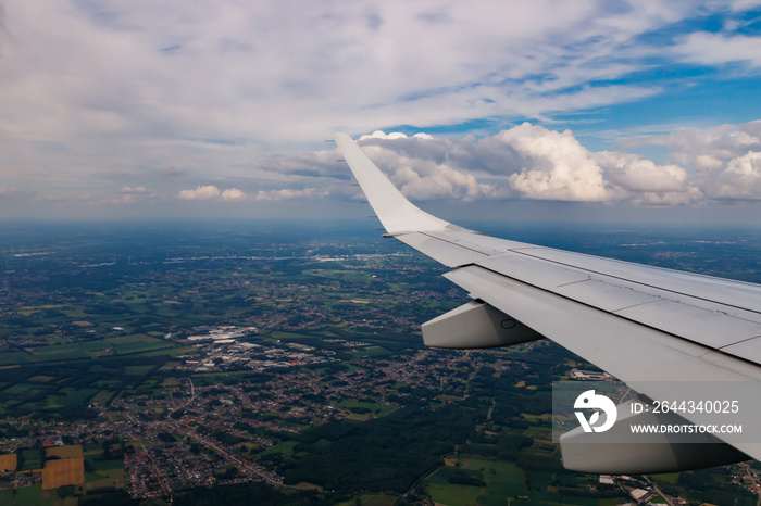 Plain wing over Belgium. Flight from Amsterdam to Brussels.