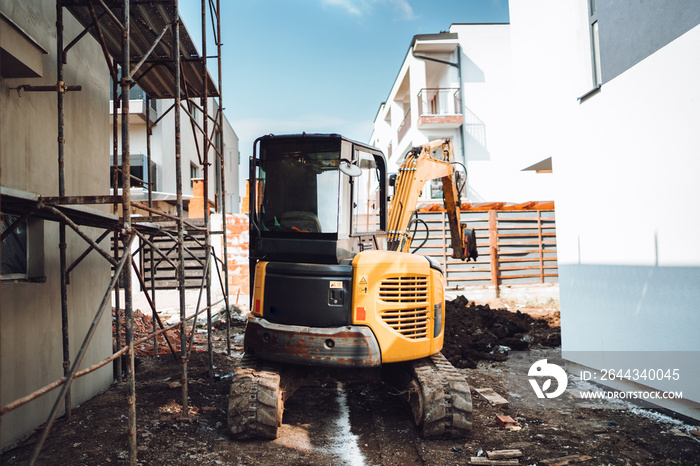 Industrial machinery excavator on construction site, Mini heavy duty excavator moving earth for foundation building