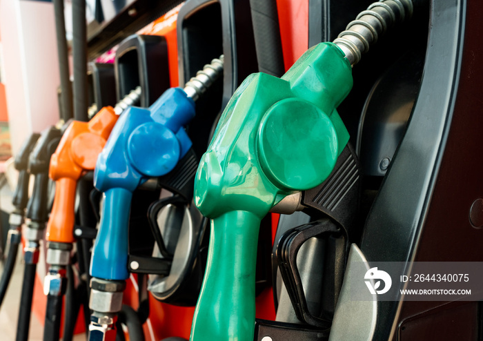 Petrol pump filling fuel nozzle in gas station. Fuel dispenser machine. Refuel fill up with petrol gasoline. Petrol industry and service. Red petrol fuel nozzle. Petroleum oil industry. Oil crisis.