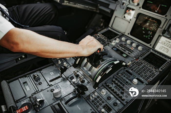 Pilot aviating during flight in cockpit of airplane