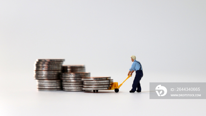 A miniature man carrying coins in a cart.