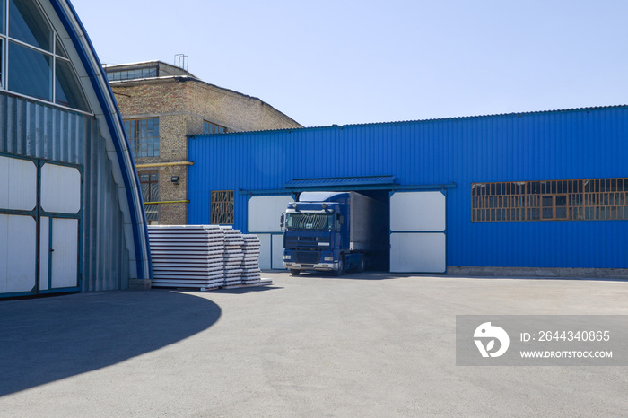 facade of an industrial building and warehouse with freight car