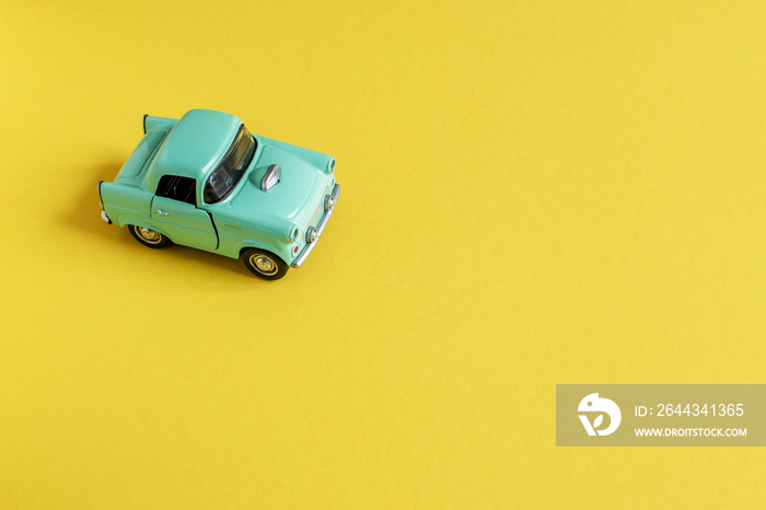 Toy car on yellow background