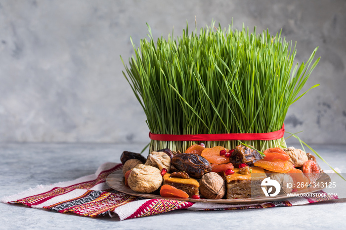 Novruz setting table decoration,  wheat grass, Azerbaijan national pastry pakhlava, new year sring celebration, nature awakening