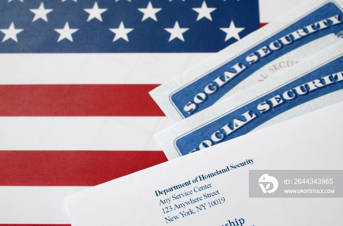 United States social security number cards lies with USCIS envelope on US flag