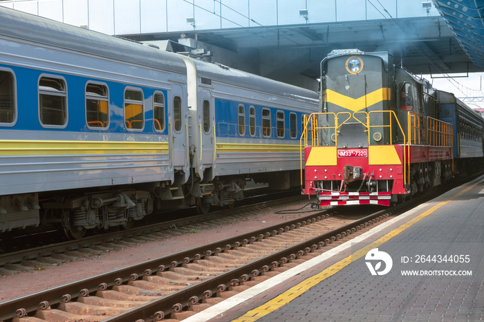 An old locomotive from the Soviet era arrives at the station. Retro locomotive arrives at the platform of the Kiev Central Railway Station