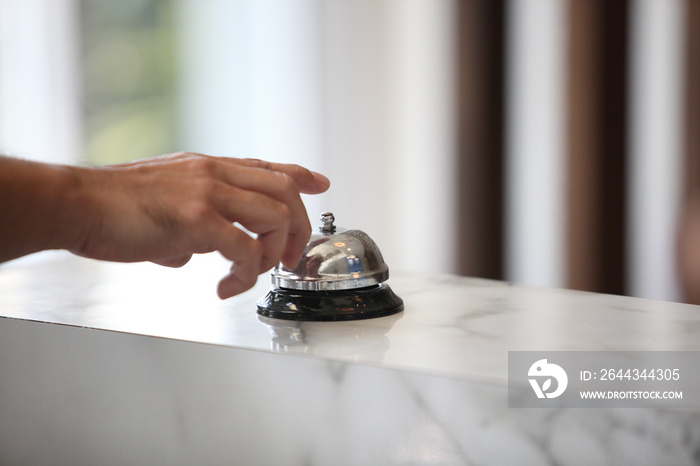 Hotel service bell on a table white glass and simulation hotel background. Concept hotel, travel, room , A service bell in a hotel