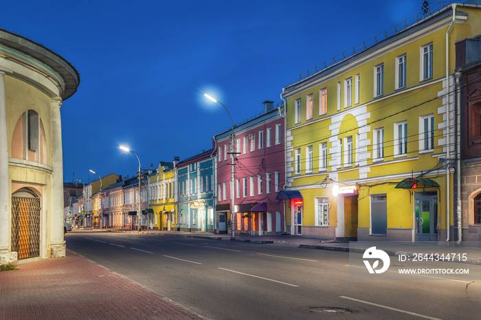 Old colorful houses located opposite to historic trading arcades on Koltsova street at dusk in Ryazan, Russia