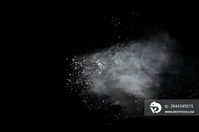 White powder explosion isolated on black background