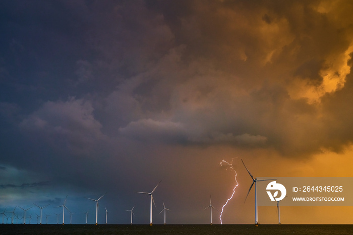 Thunderstorm on the IJsselmeer with windmills in the background.