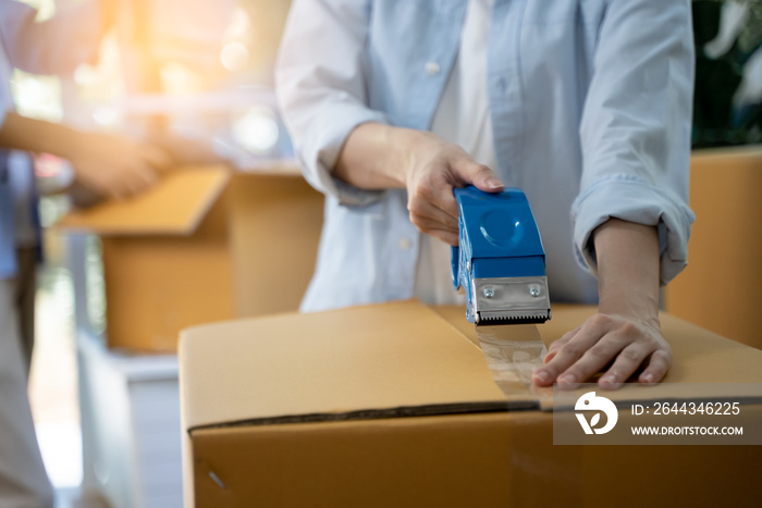 close up person sealing tape on parcel box prepare for delivery service to pick up.