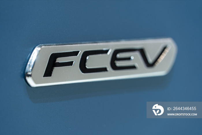 Close up of nameplate FСEV (Fuel cell electric vehicle) on board of hydrogen powered car.