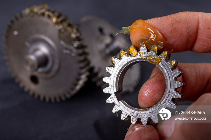 Coating the gears with grease. Accessories and spare parts for industrial machinery.