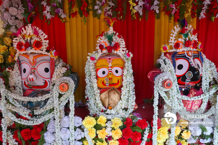 Idols of God Jagannath, Balaram and Goddess Suvadra. Lord Jagannath is being worshipped with garlands for Rath jatra festival - at Howrah, West Bengal, India.