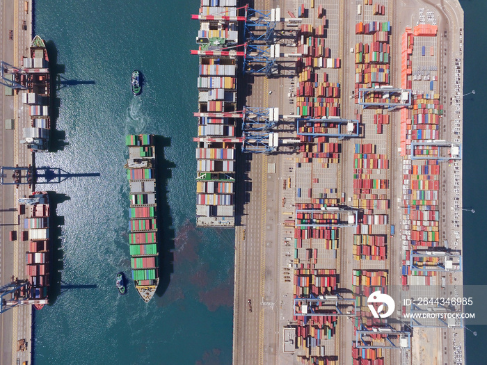 Commercial port with container ships - Top down aerial view.