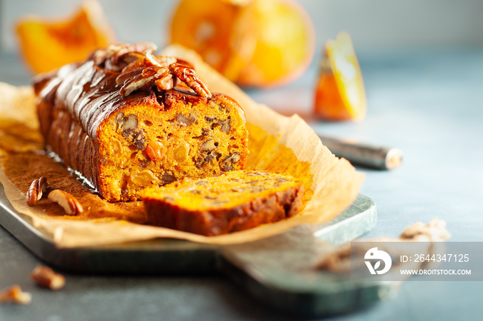 Delicious pumpkin pecan and raisin cake on cutting board. Loaf of pumpkin bread.