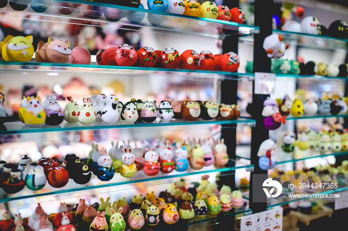 Traditional craft cotton toy with form of animals, daruma, people, and food at store in Nishiki Market, Kyoto, Japan