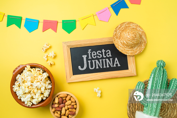 Festa Junina party background with popcorn, peanuts and chalkboard. Brazilian summer harvest festival concept. Top view, flat lay