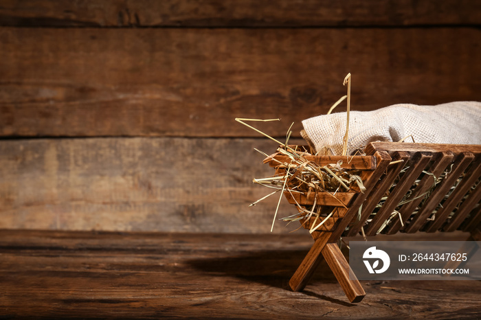 Manger with baby on wooden background. Concept of Christmas story