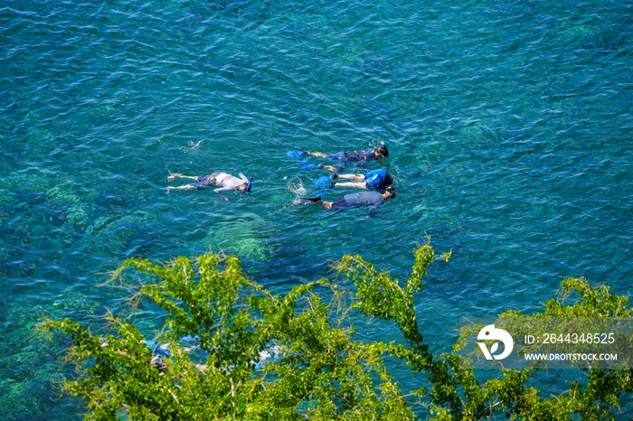 Snorkelers in Honolua Bay along the Honoapiilani Highway in the west of Maui island in Hawaii, United States