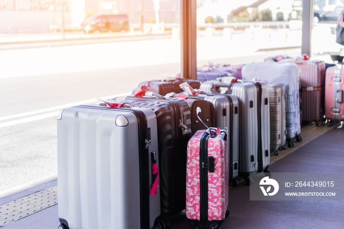 Group tour trip vacation or holiday tourism insurance concept : Large suitcases or baggage front road at hotel waiting bus tours with light flare.