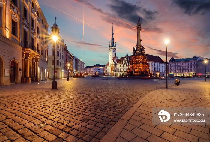 Town hall and Holy Trinity Column in Olomouc during sunset.