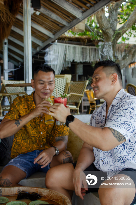 Male friends having drinks on vacation