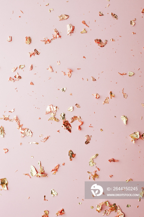 Pink festive background of golden glitter foil confetti