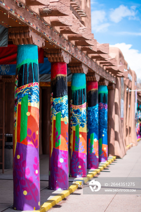 Colorful columns on adobe building