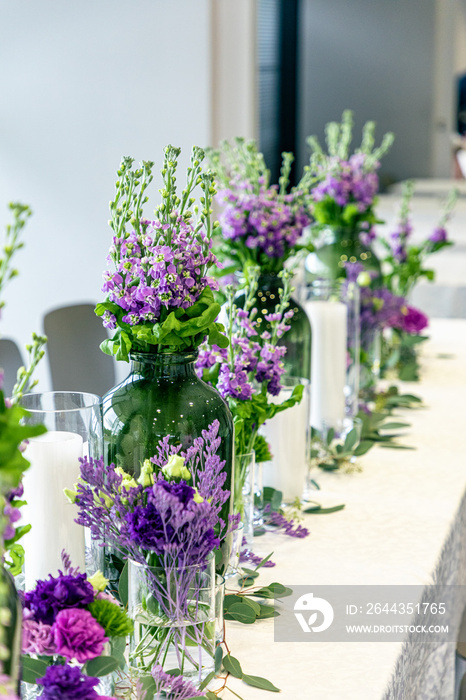 Purple and violet wedding flower arrangements, made out of carnations lisianthus and matthiola flowers.