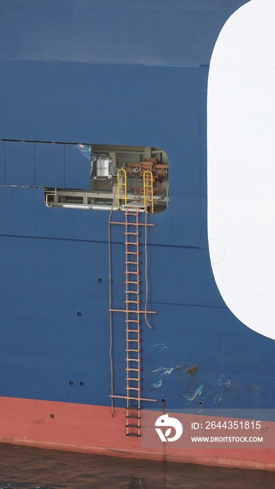 Pilot boarding arrangement. Crew of the cargo ship rigging the pilot ladder. Pilot transfer arrangement.