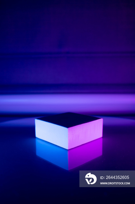 geometric podium in neon vibrant purple and blue lighting. place for the product. place for text. minimalistic stylish concep