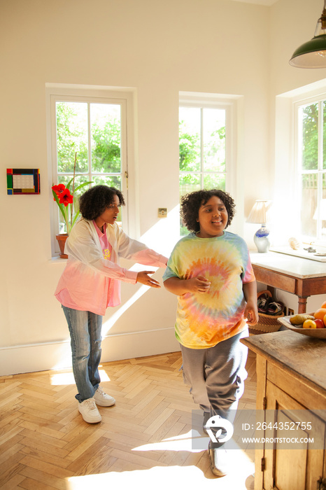 Two siblings having fun in the kitchen