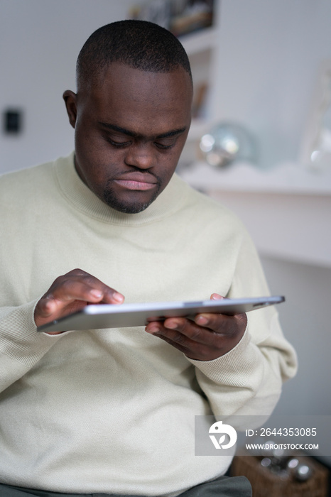 Man with Down syndrome using tablet