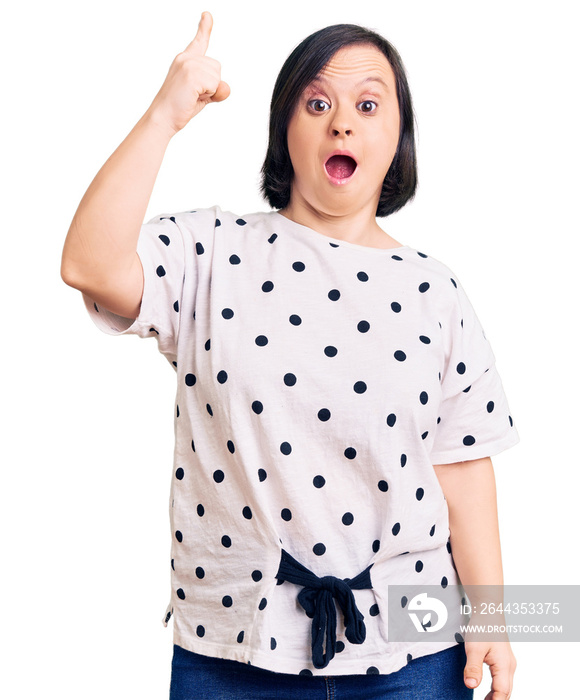 Brunette woman with down syndrome wearing casual clothes pointing finger up with successful idea. exited and happy. number one.