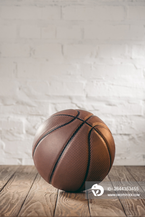 one brown basketball ball on wooden floor