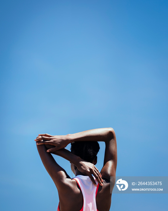 Fitness woman doing warmup exercise outdoors