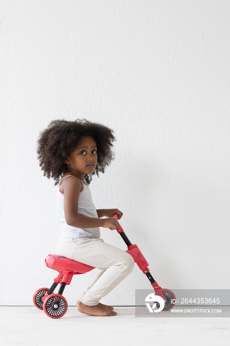 Portrait of girl riding on tricycle