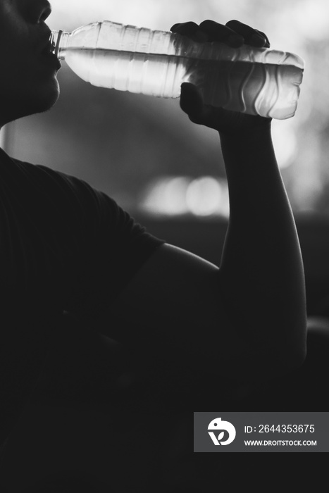 Young Man Drinking Water At Gym