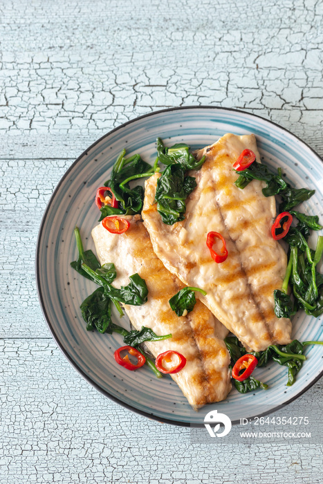 Grilled sea bream fish fillet with spinach