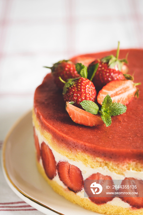 Close up view rench strawberry cake Fraisier on white plate.