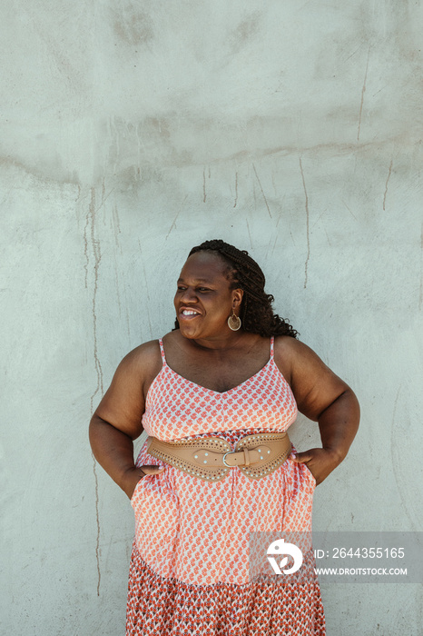 portrait of an African American woman standing with hands in pockets