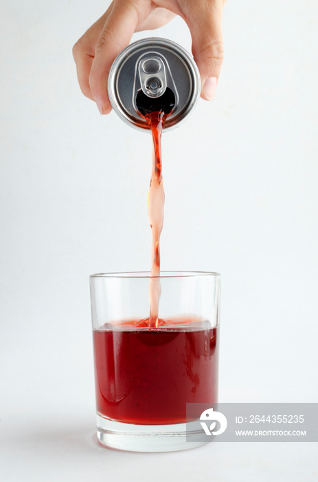 Woman pouring sweet flavoring soda drink into the glass, white background