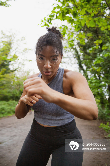 Young curvy woman with vitiligo working out in the park looking fierce