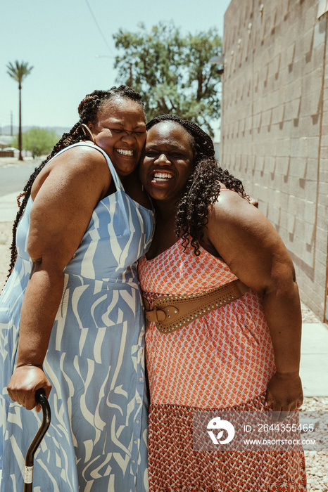 2 plus size African American women hug